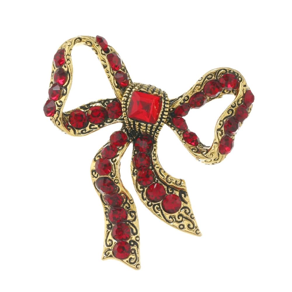 This eye-catching brooch features a classic bow design, crafted with an antiqued gold-tone metal base intricately adorned with vibrant red crystals. A large, faceted red gemstone anchors the center, while delicate filigree detailing adds vintage charm. Perfect for elevating blazers, scarves, or festive outfits, this bold piece brings a touch of glamorous retro style to any look. 05