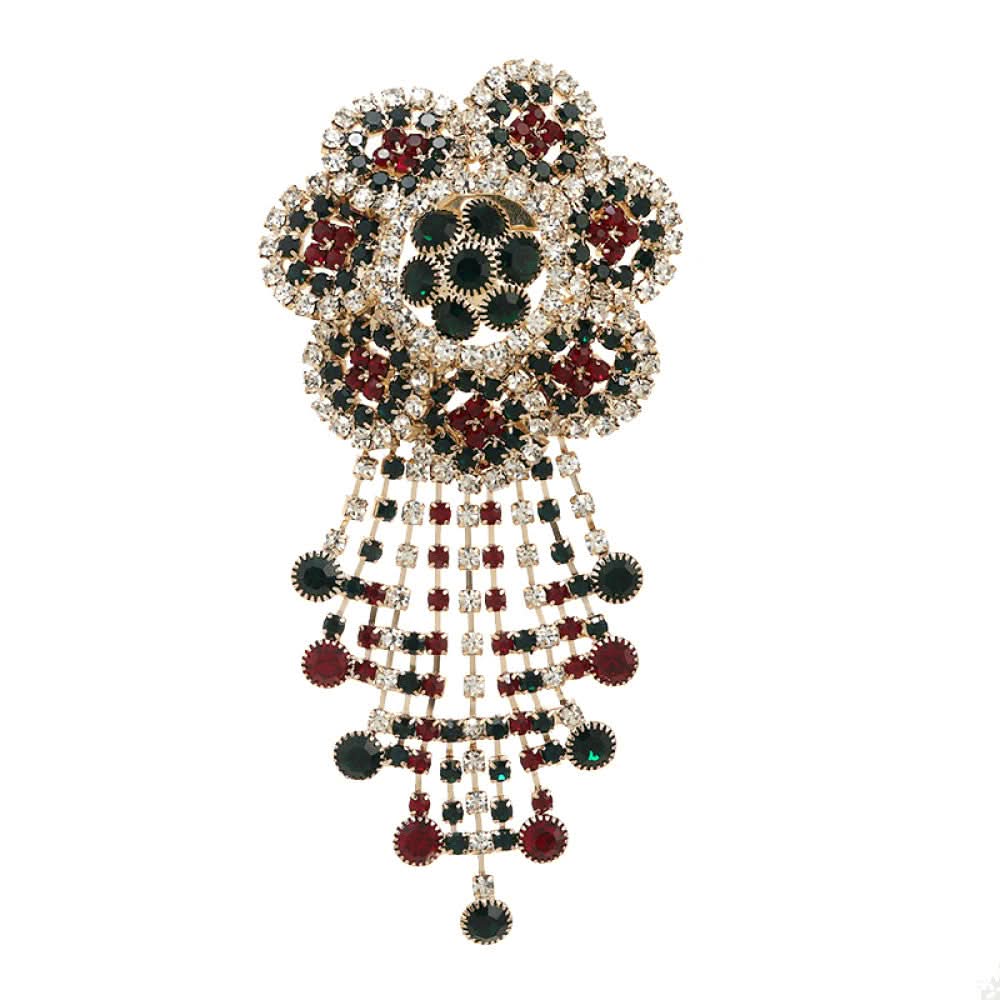 This ornate multi-layer floral brooch features vibrant red and green gemstones set in a clear crystal frame, adding a touch of vintage glamour to any outfit. Measures approx. 5x5cm 09