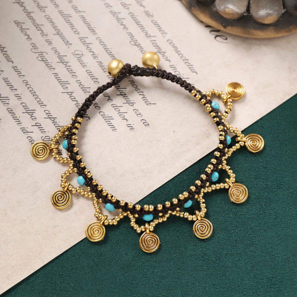 Antique gold coin charms with turquoise accents, bohemian and eye-catching.