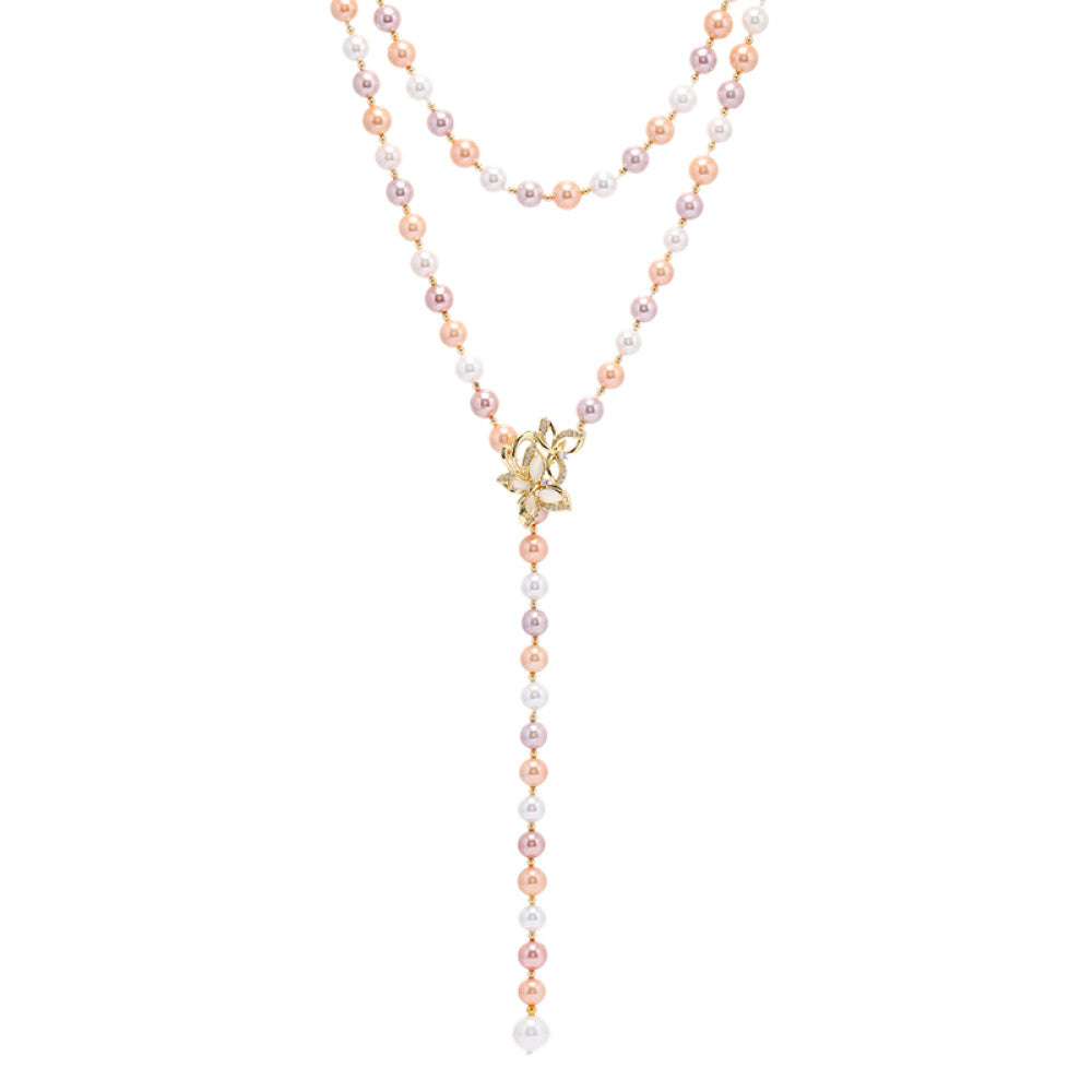 Elegant multi-colored pearl Y-necklace with gold floral accent, featuring layered strands and a drop pendant, ideal for vintage-inspired formal or special occasion wear, displayed on a black mannequin against a red fabric background 04