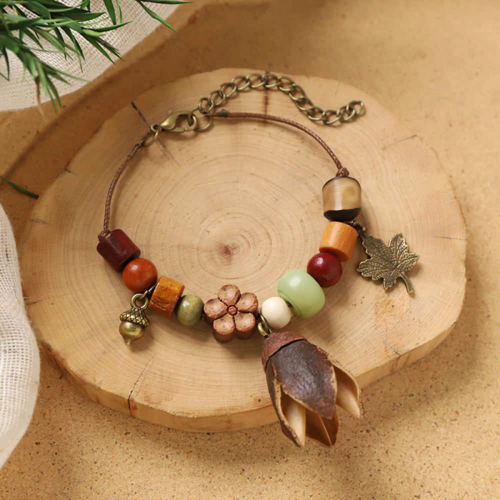 Wood beads wrapped in silver wire, handcrafted rustic elegance.