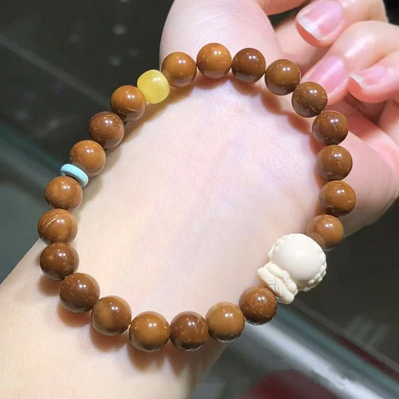 Brown wood bead bracelet with carved charm and colorful accents | DIY Jade