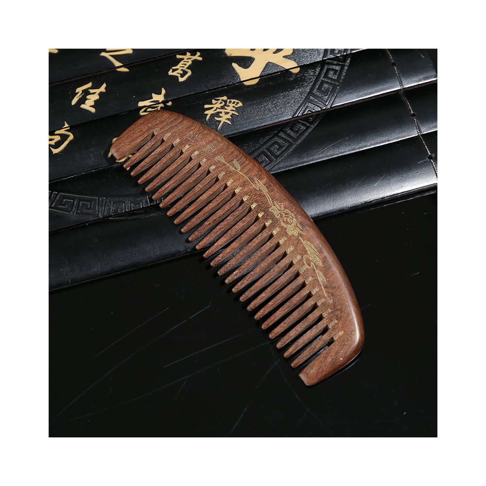 Closeup of engraved wooden hair comb detail