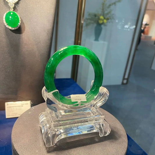 Vibrant emerald green jade bangle displayed in luxury showcase, elegant presentation | DIY Jade