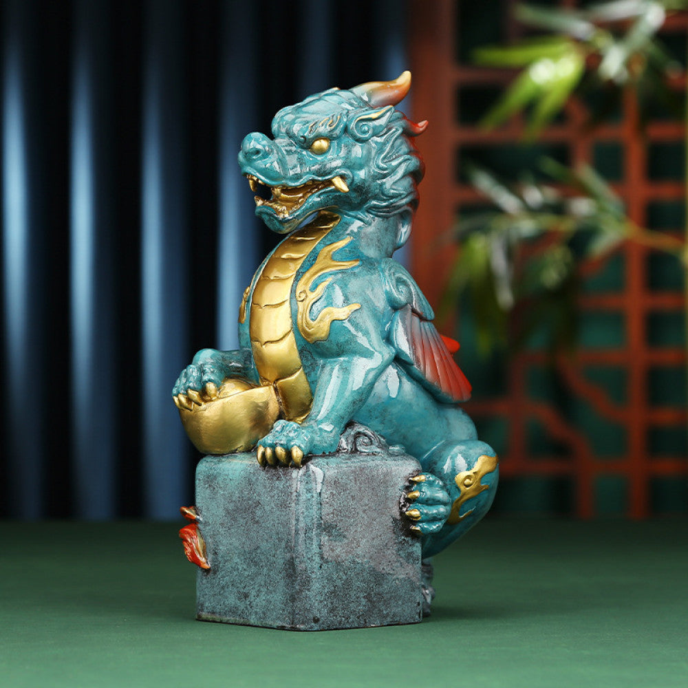Intricate teal and gold Chinese dragon statue, a symbol of power and good fortune in feng shui, placed on a square base against a warm-toned background 02