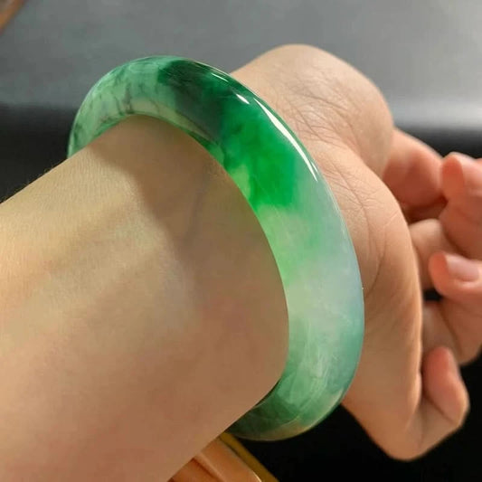 Green floating flower jadeite bangle worn on wrist, showing elegant everyday fit | DIY Jade