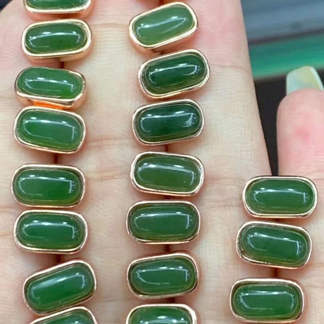 Rose gold stud earrings with rectangular green jade cabochons, bulk display on hand | DIY Jade