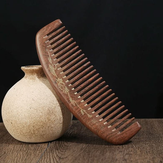 Hand carved wooden hair comb with floral engraving