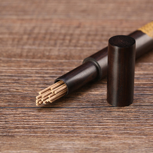 Handcrafted ebony incense tube with copper inlay detail