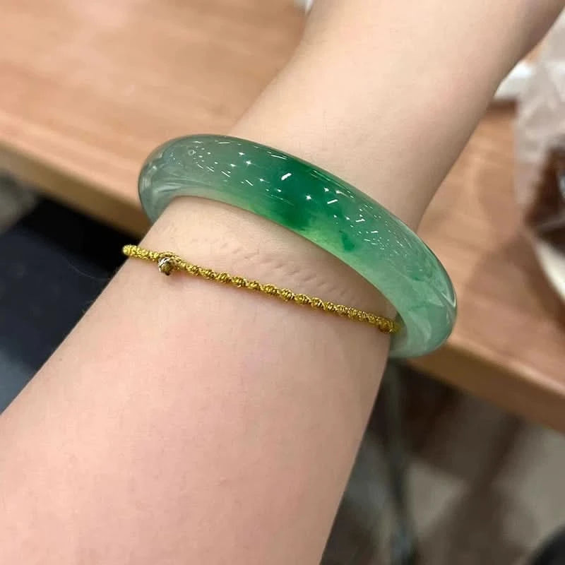 Natural icy pale green translucent jade bangle worn on wrist, elegant everyday styling | DIY Jade