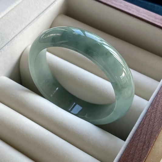 Light blue jade bangle with natural patterns, displayed in elegant jewelry box | DIY Jade