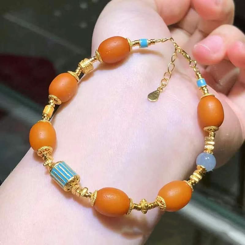 Orange amber bracelet with gold accents and blue enamel details | DIY Jade