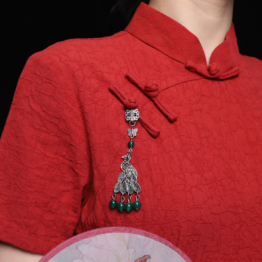 Peacock brooch worn on red cheongsam, traditional style | DIY Jade