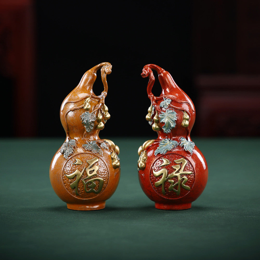Pair of traditional Chinese gourd statues with "Fu" and "Lu" luck symbols, colorful enamel details, placed on green surface against dark background