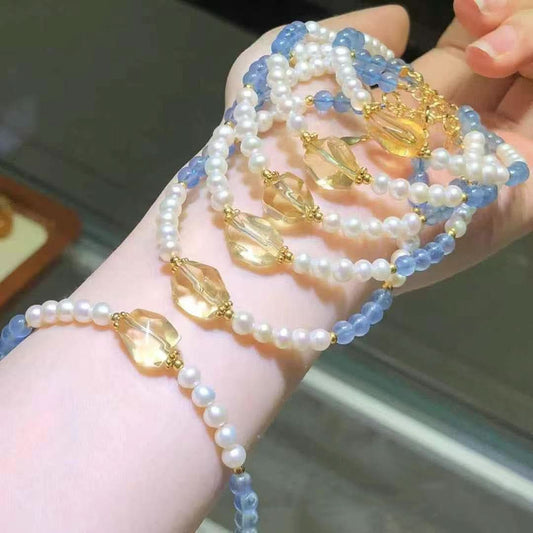 Multiple blue crystal and pearl bracelets with yellow quartz accents, stacked effect | DIY Jade