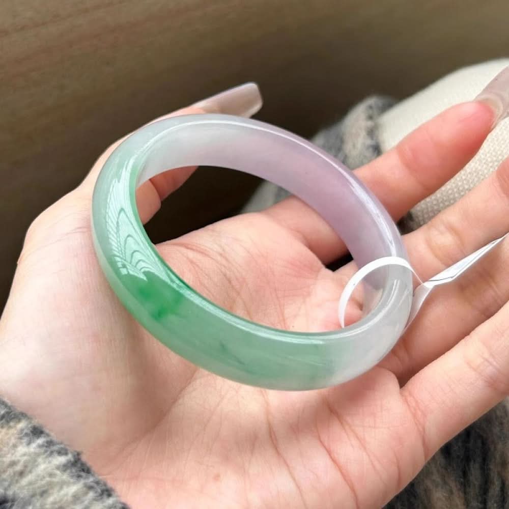 Tri-color green purple white jade bangle held in palm, showing soft gradient texture | DIY Jade