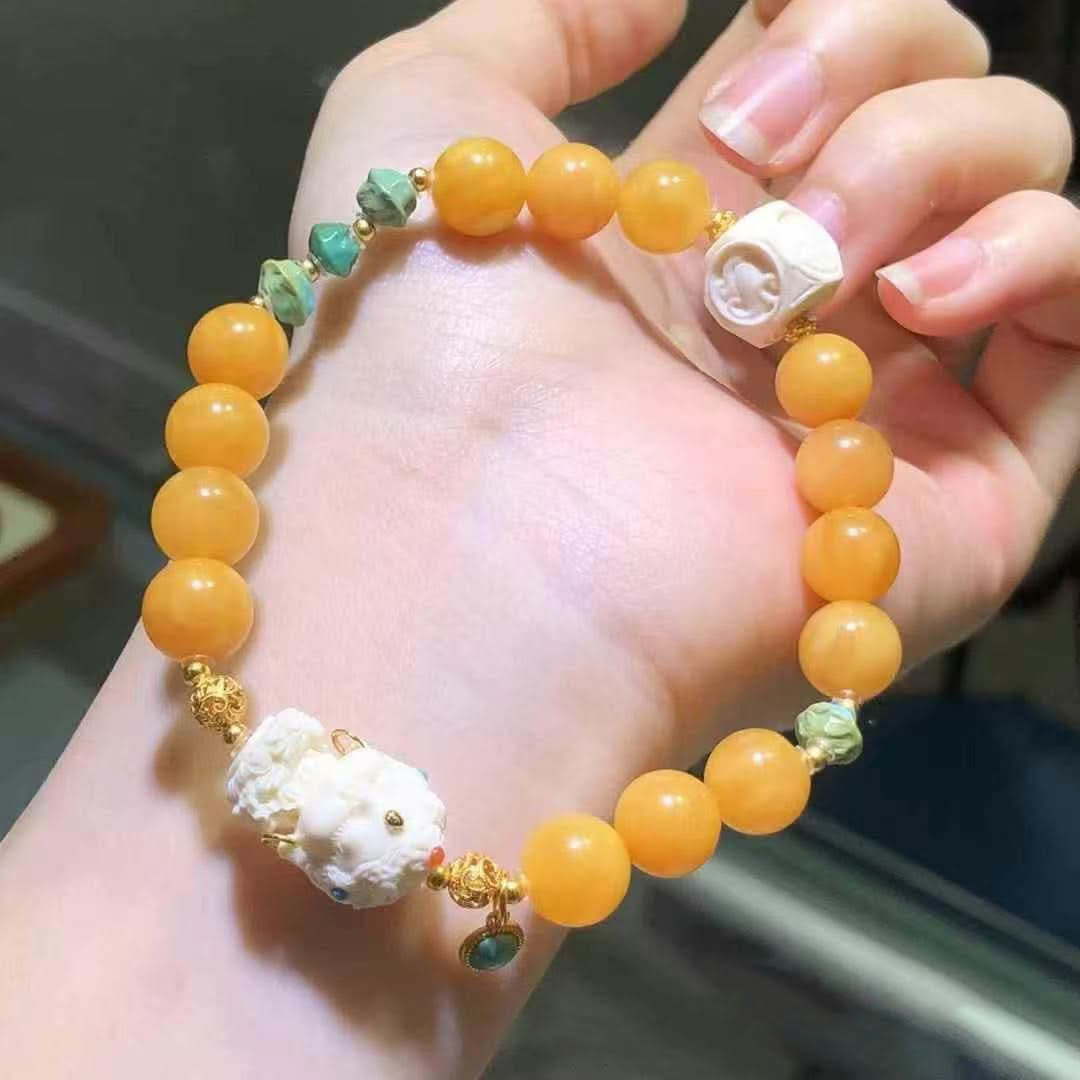 Yellow amber round bead bracelet with carved charms and turquoise accents | DIY Jade