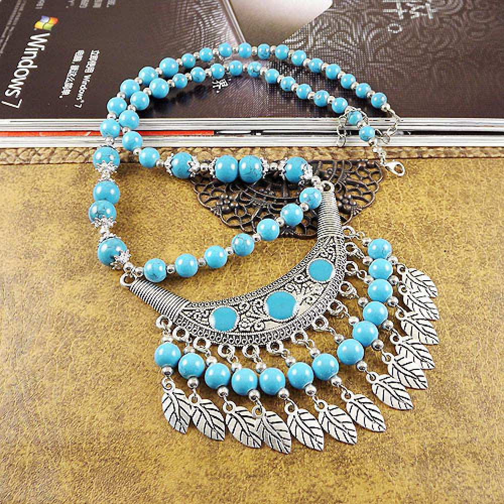 Vintage black beaded necklace with intricate silver-toned leaf tassel and crescent pendant, featuring black beads and gothic tribal design, ideal for bohemian goth fashion, showcased on a textured surface with vintage accents 11