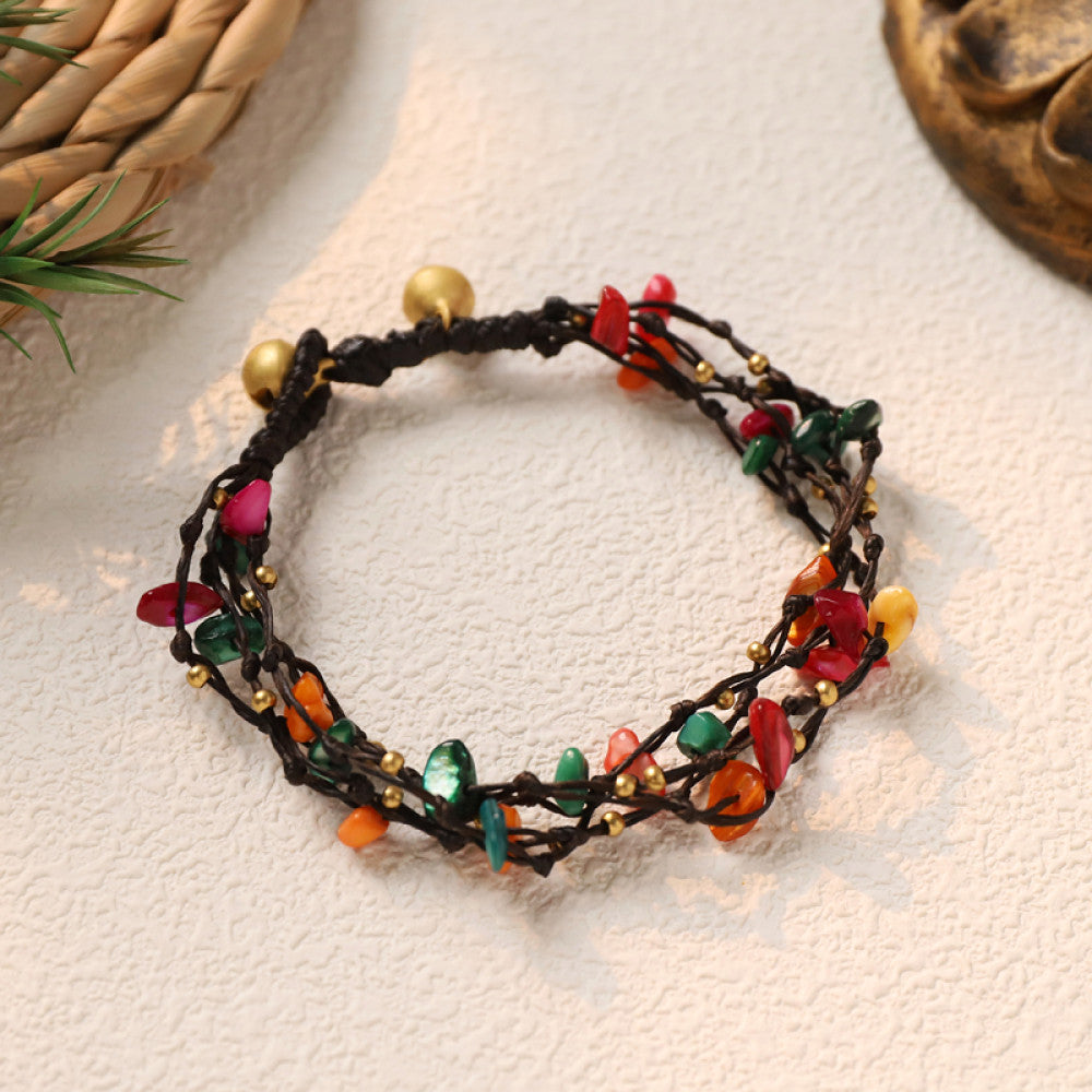 This multi-layered bohemian bracelet features black braided cords adorned with natural amethyst chips and gold beads, finished with golden accent beads. A unique, earthy accessory for everyday style 01