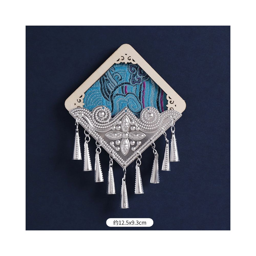 Blue diamond-pattern fridge magnet with hanging tassels.