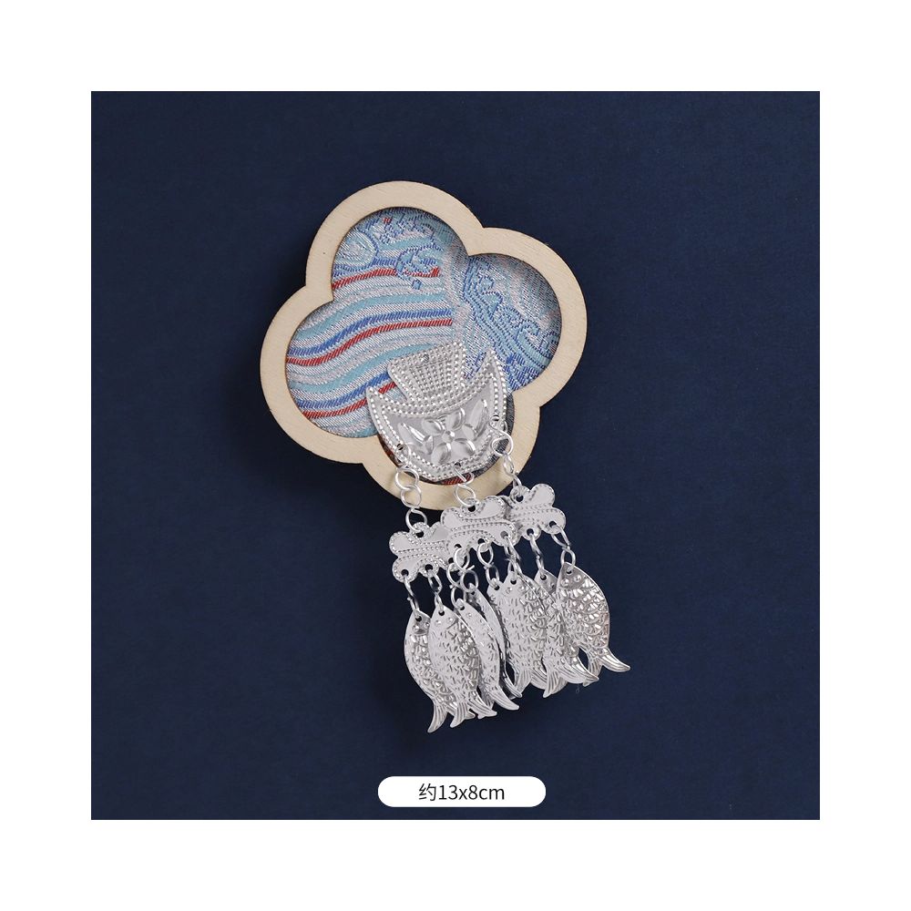 Blue royal-style magnet with decorative tassels.