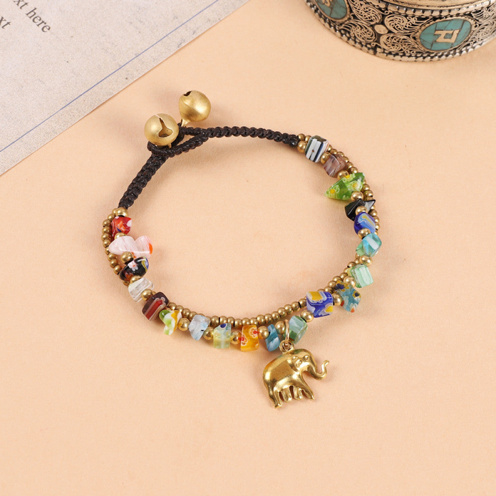 This double-layered bohemian bracelet features vibrant multicolored beads, golden bells, and a charming gold elephant charm. The adjustable knot closure ensures a perfect fit, adding a playful, ethnic-inspired touch to any outfit 1