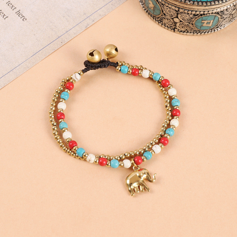 This double-layered bohemian bracelet features vibrant multicolored beads, golden bells, and a charming gold elephant charm. The adjustable knot closure ensures a perfect fit, adding a playful, ethnic-inspired touch to any outfit 2