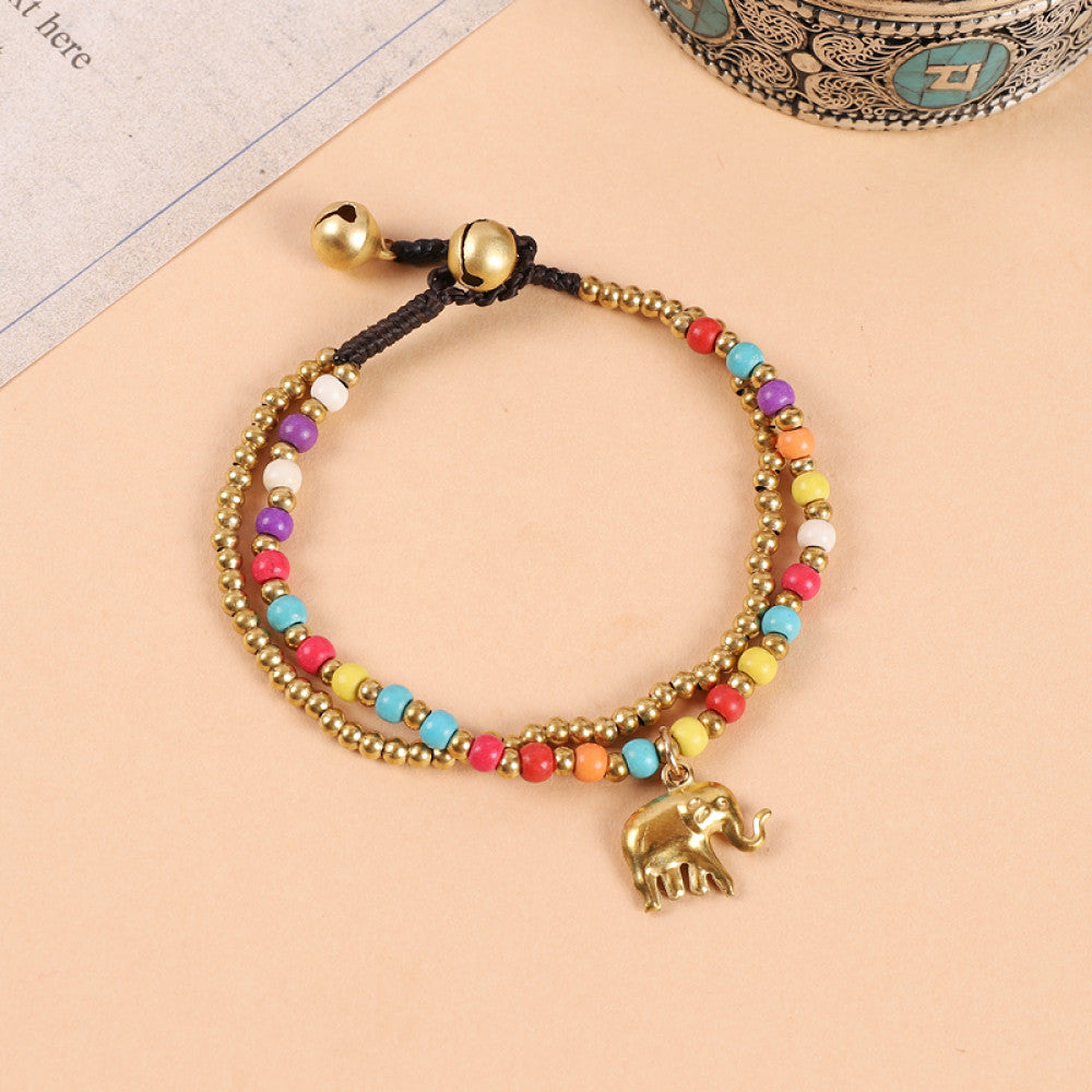 This double-layered bohemian bracelet features vibrant multicolored beads, golden bells, and a charming gold elephant charm. The adjustable knot closure ensures a perfect fit, adding a playful, ethnic-inspired touch to any outfit 3
