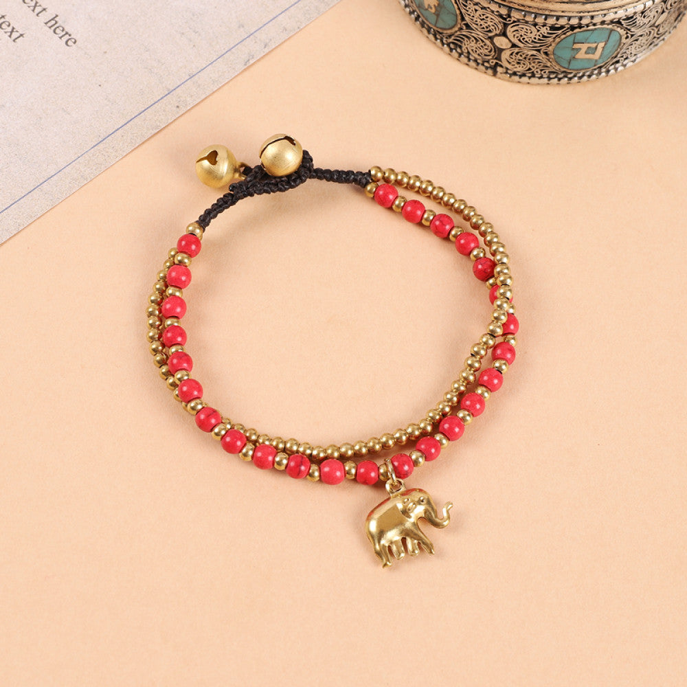 This double-layered bohemian bracelet features vibrant multicolored beads, golden bells, and a charming gold elephant charm. The adjustable knot closure ensures a perfect fit, adding a playful, ethnic-inspired touch to any outfit 5