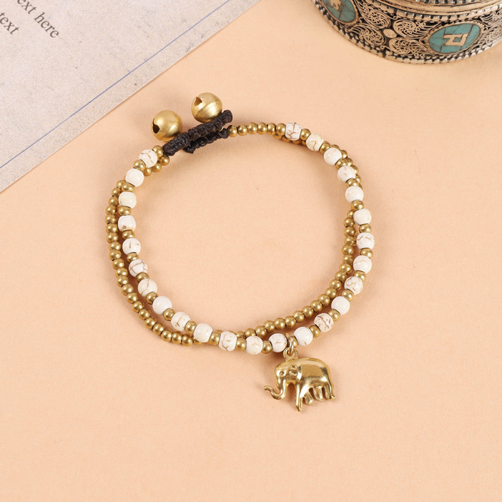 This double-layered bohemian bracelet features vibrant multicolored beads, golden bells, and a charming gold elephant charm. The adjustable knot closure ensures a perfect fit, adding a playful, ethnic-inspired touch to any outfit 6