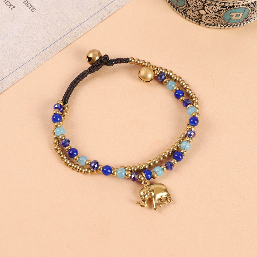 This double-layered bohemian bracelet features vibrant multicolored beads, golden bells, and a charming gold elephant charm. The adjustable knot closure ensures a perfect fit, adding a playful, ethnic-inspired touch to any outfit 7