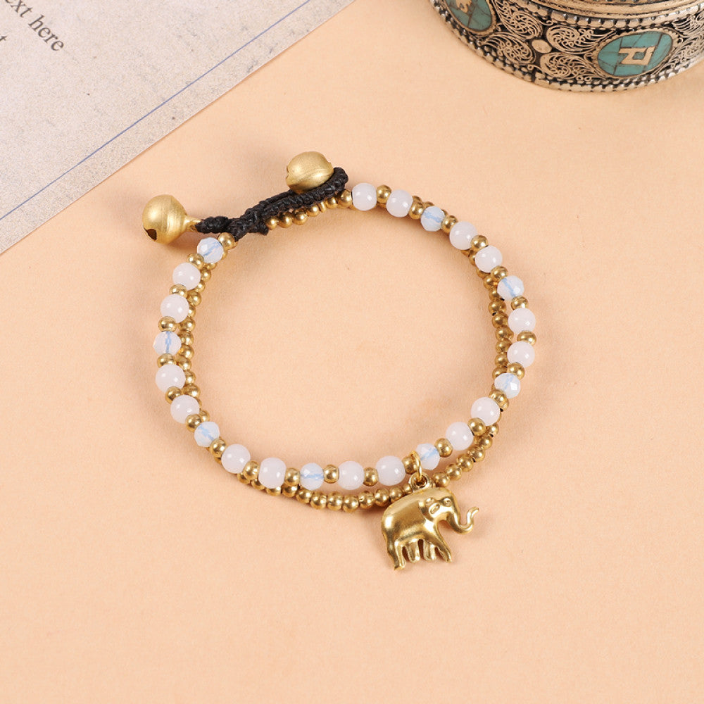 This double-layered bohemian bracelet features vibrant multicolored beads, golden bells, and a charming gold elephant charm. The adjustable knot closure ensures a perfect fit, adding a playful, ethnic-inspired touch to any outfit 8