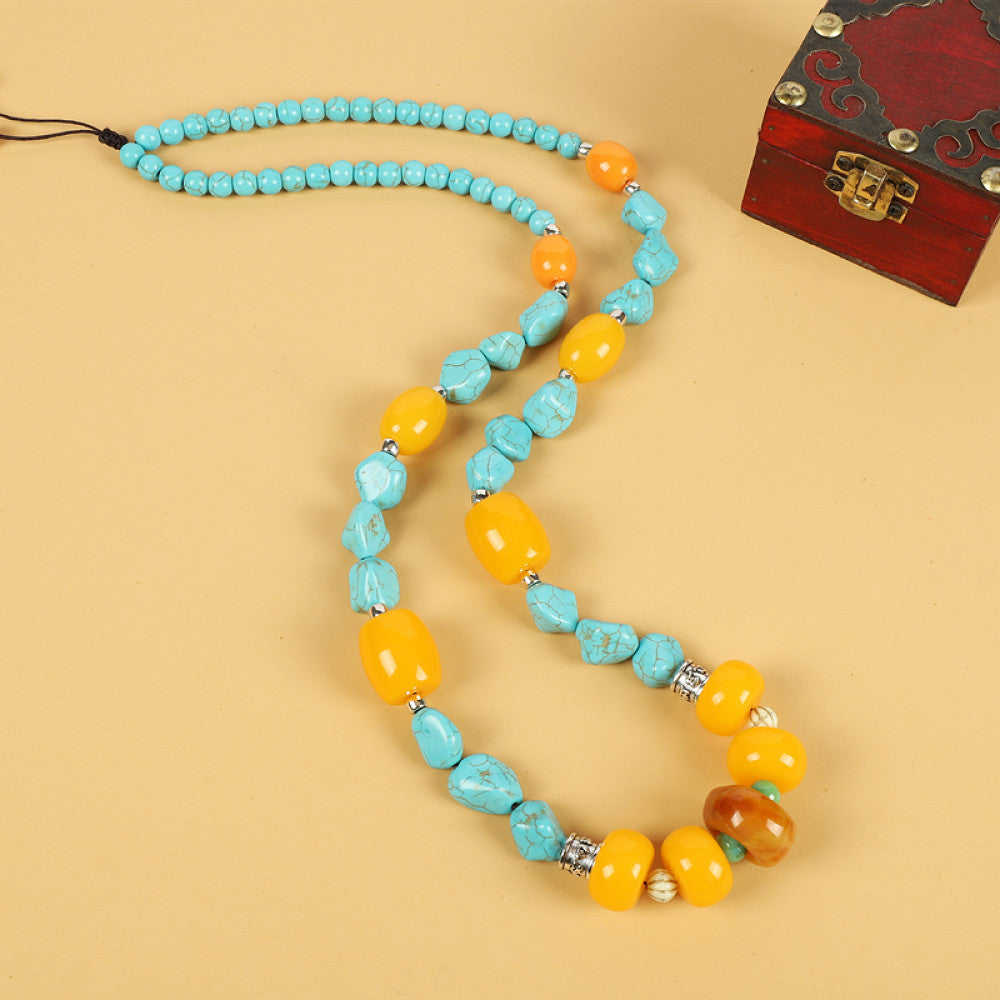Vintage bohemian ethnic tribal necklace with multi-color beads (black, orange, red, turquoise, yellow) and intricate patterned accents, ideal for boho chic fashion, displayed against a neutral background with a vintage box accent 04