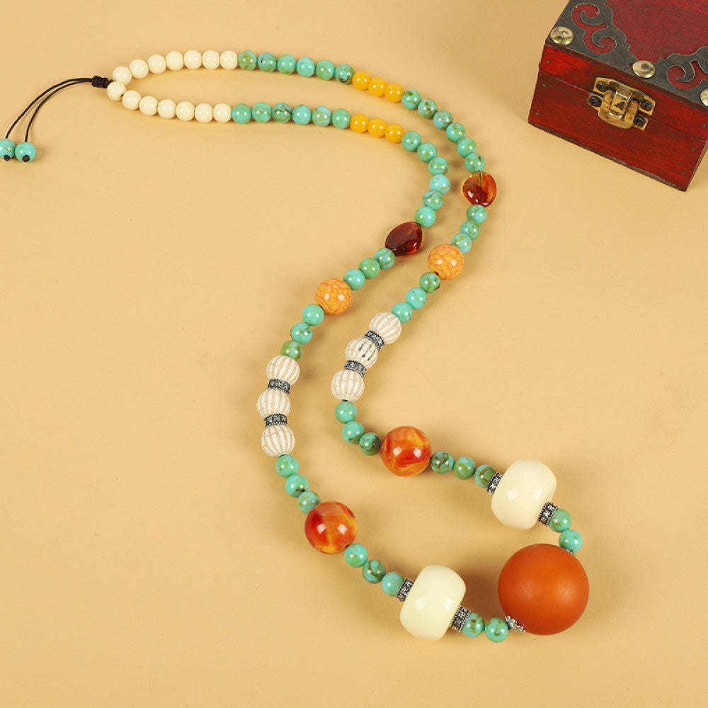 Vintage bohemian ethnic tribal necklace with multi-color beads (black, orange, red, turquoise, yellow) and intricate patterned accents, ideal for boho chic fashion, displayed against a neutral background with a vintage box accent 05