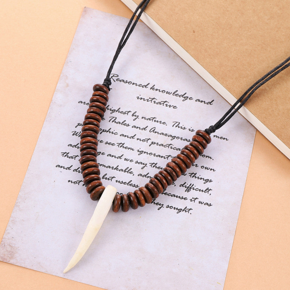 Vintage bohemian tribal necklace with bone accents and black cord, displayed on vintage paper, ideal for ethnic wilderness and boho fashion 04