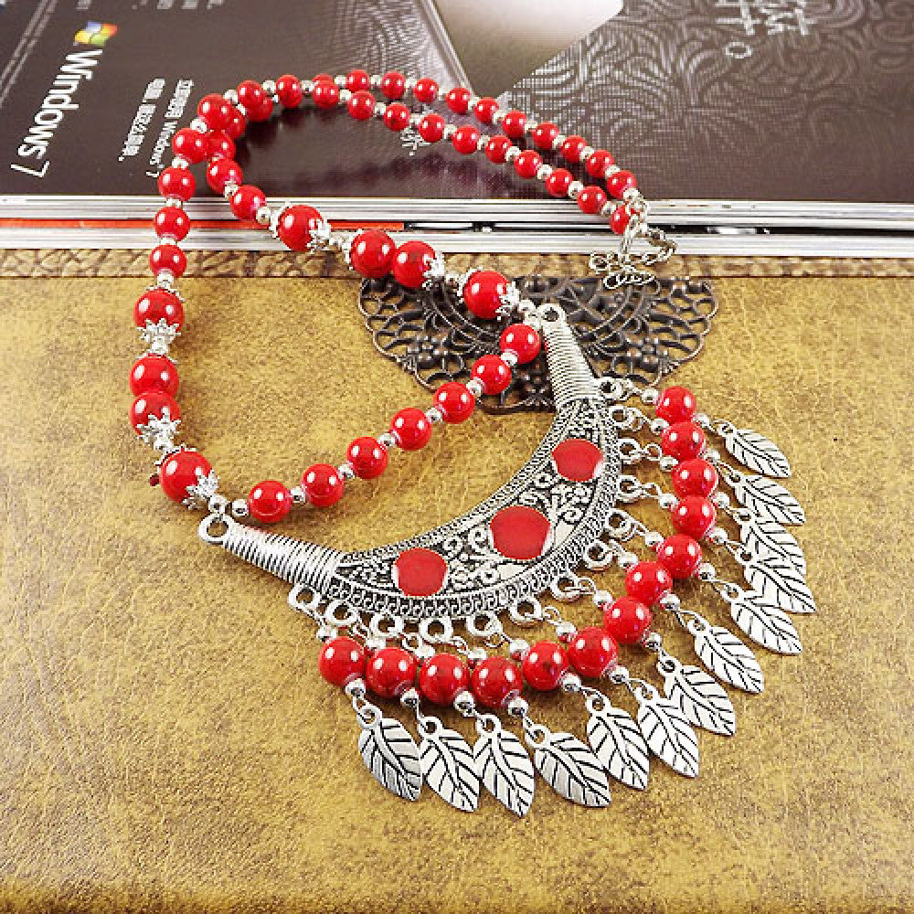 Vintage black beaded necklace with intricate silver-toned leaf tassel and crescent pendant, featuring black beads and gothic tribal design, ideal for bohemian goth fashion, showcased on a textured surface with vintage accents 09