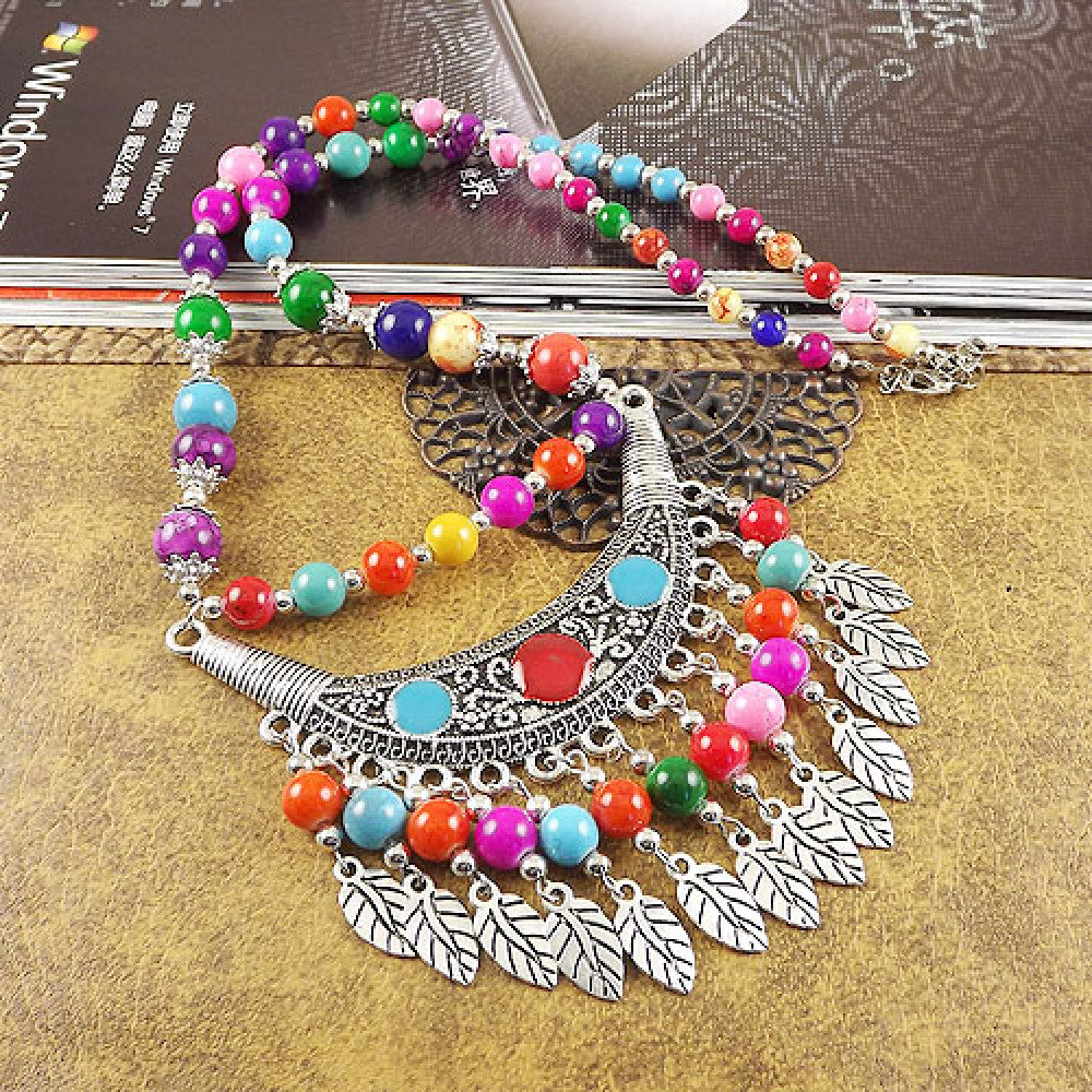 Vintage black beaded necklace with intricate silver-toned leaf tassel and crescent pendant, featuring black beads and gothic tribal design, ideal for bohemian goth fashion, showcased on a textured surface with vintage accents 02