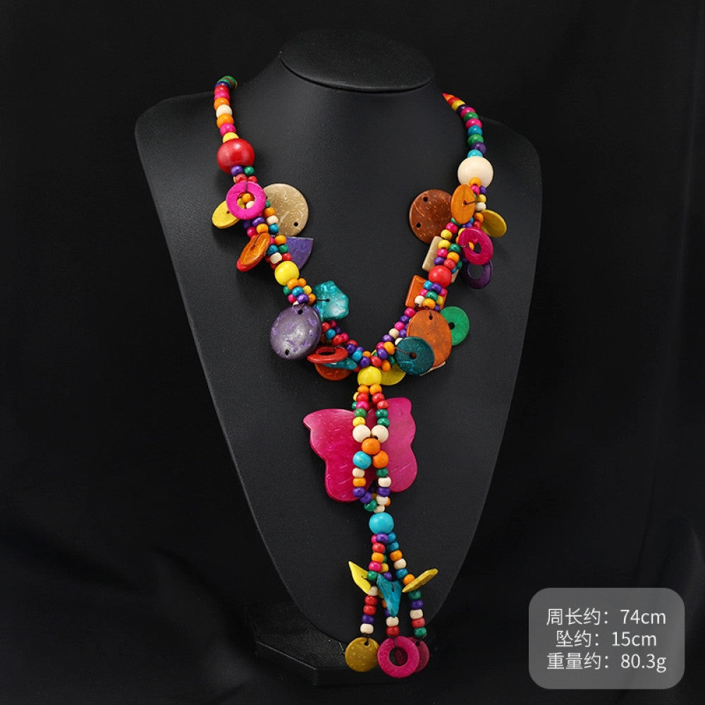 Vintage bohemian colorful shell and beaded necklace with tropical floral pendant, featuring multi-color beads and shell accents, ideal for boho beach and ethnic fashion, displayed on a black mannequin against a dark background 02