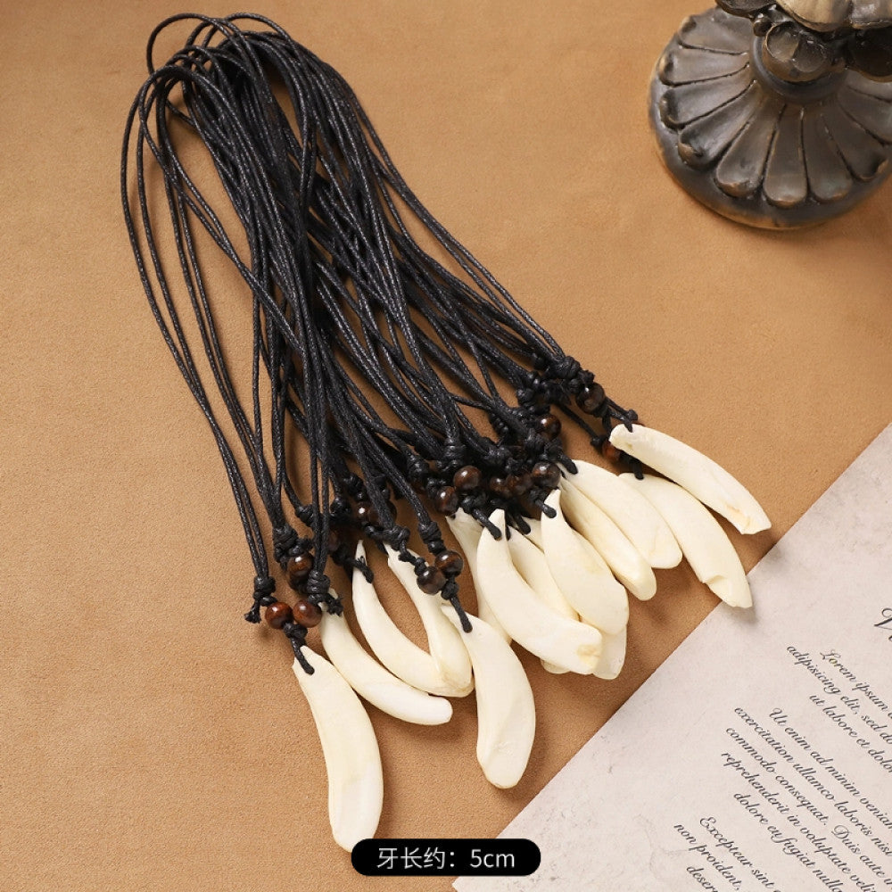 Vintage bohemian ethnic necklace set with animal tooth pendants, black leather cords, and bead accents, displayed against a neutral background with decorative elements, ideal for tribal and boho fashion enthusiasts 02