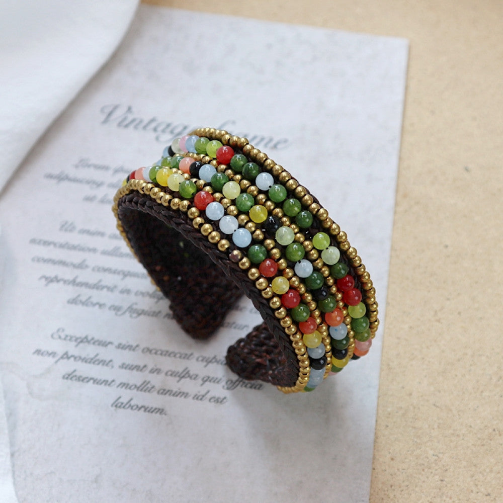 Vintage bohemian ethnic beaded cuff bracelet with turquoise and red beads, woven design, displayed on vintage paper, ideal for boho fashion enthusiasts 01