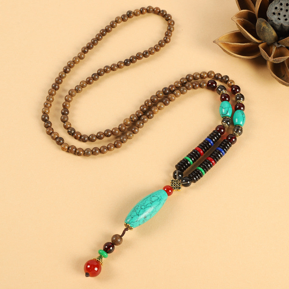 Vintage bohemian ethnic beaded necklace with intricate seed pendant and multi-color beads, ideal for spiritual boho fashion, displayed with a decorative flower against a neutral background 05