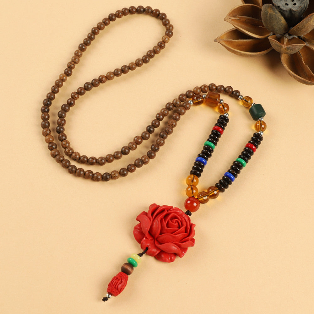 Vintage bohemian ethnic beaded necklace with jade pendant and multi-color beads, ideal for spiritual boho fashion, displayed with a decorative flower against a neutral background 02