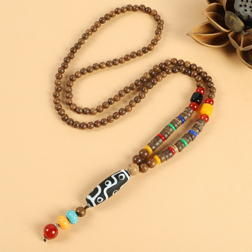 Vintage bohemian ethnic beaded necklace with jade pendant and multi-color beads, ideal for spiritual boho fashion, displayed with a decorative flower against a neutral background 03