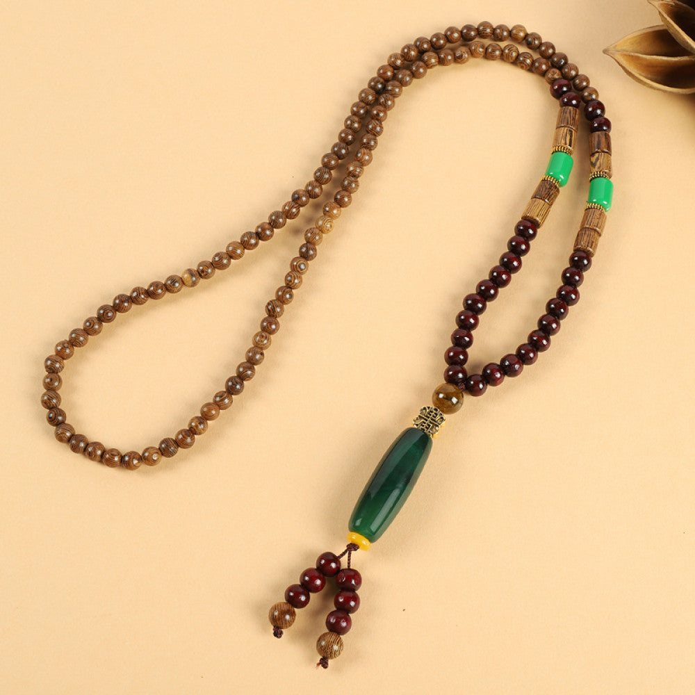 Vintage bohemian ethnic beaded necklace with jade pendant and multi-color beads, ideal for spiritual boho fashion, displayed with a decorative flower against a neutral background 07