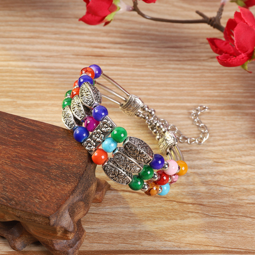 Vintage bohemian ethnic colorful beaded bracelet with multi-color stone beads and silver accents, displayed on a wooden surface, ideal for boho fashion enthusiasts 08