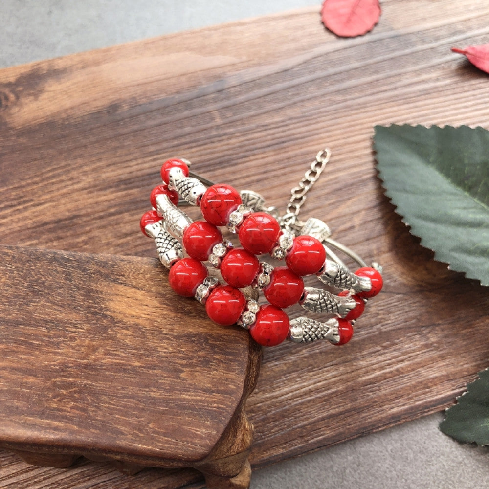 Vintage bohemian ethnic colorful beaded bracelet set with silver fish accents, displayed on a wooden surface, ideal for boho fashion enthusiasts 01