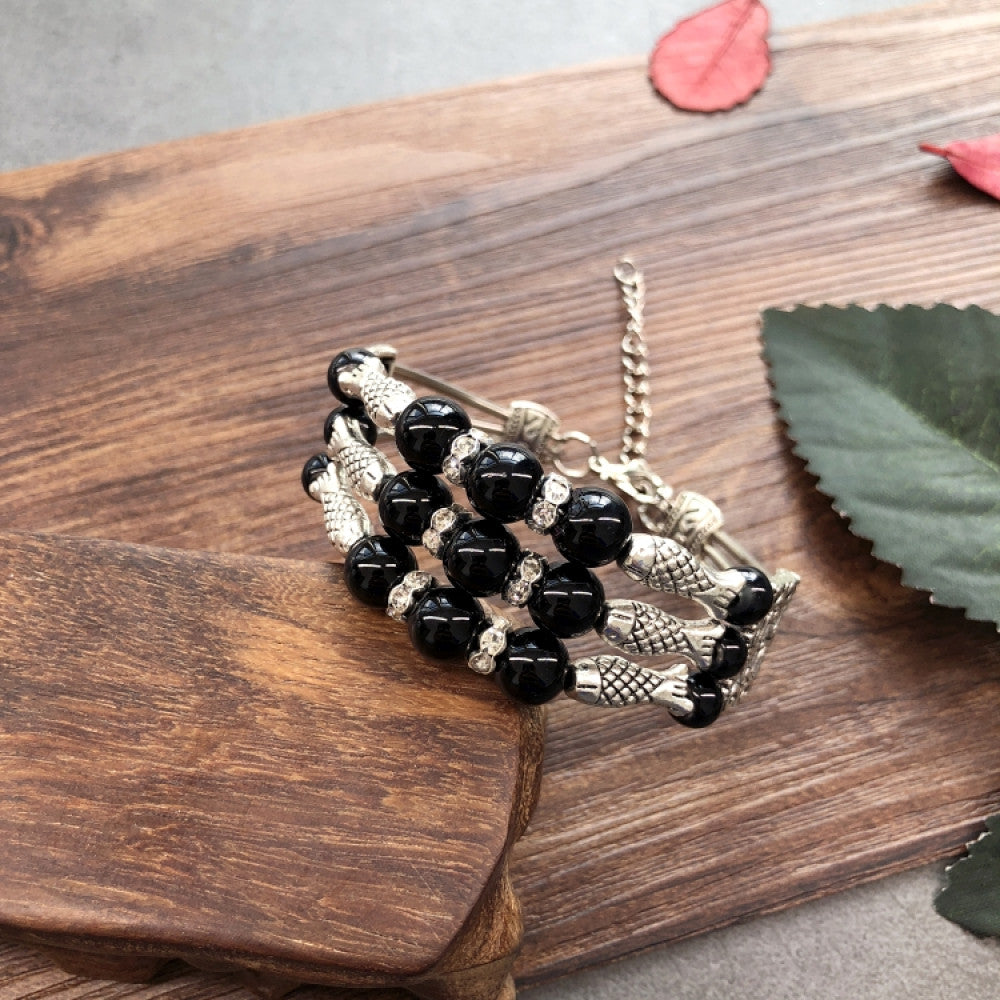 Vintage bohemian ethnic colorful beaded bracelet set with silver fish accents, displayed on a wooden surface, ideal for boho fashion enthusiasts 02