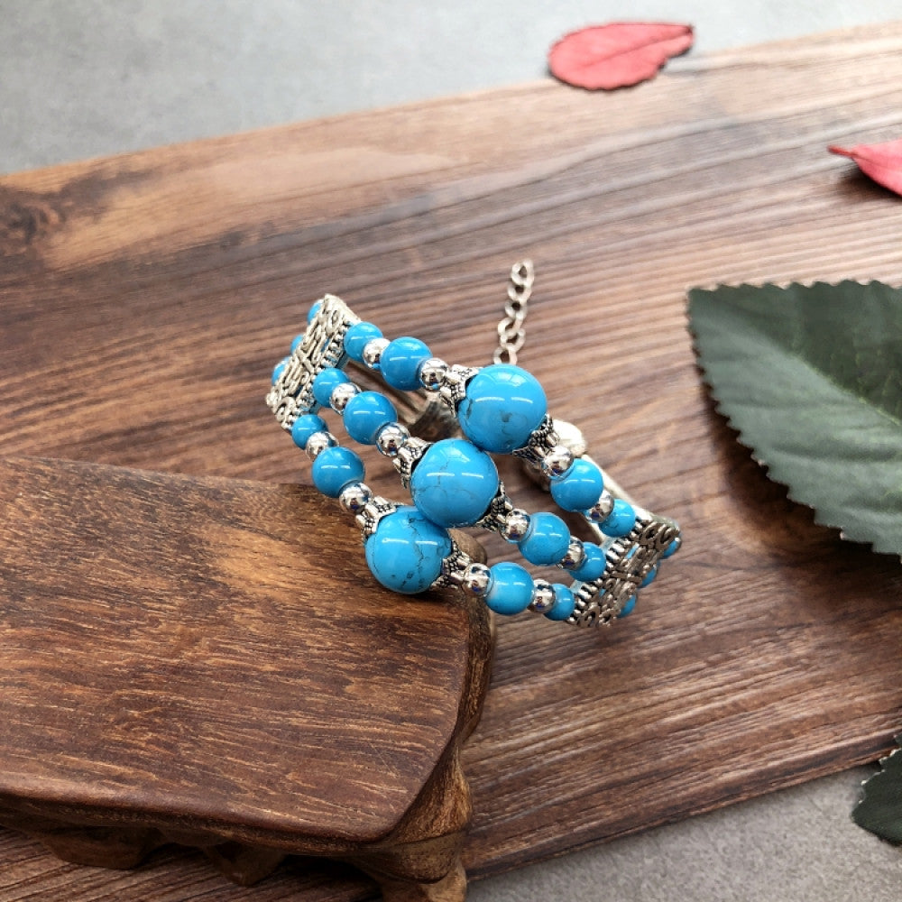 Vintage bohemian ethnic colorful beaded bracelet set with silver fish accents, displayed on a wooden surface, ideal for boho fashion enthusiasts 07