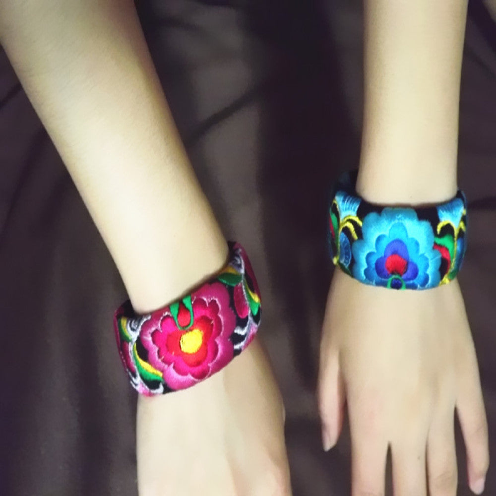 Vintage bohemian ethnic embroidered cuff bracelet with colorful floral design and black bead chain, displayed on wooden surface, ideal for boho and ethnic fashion enthusiasts 01