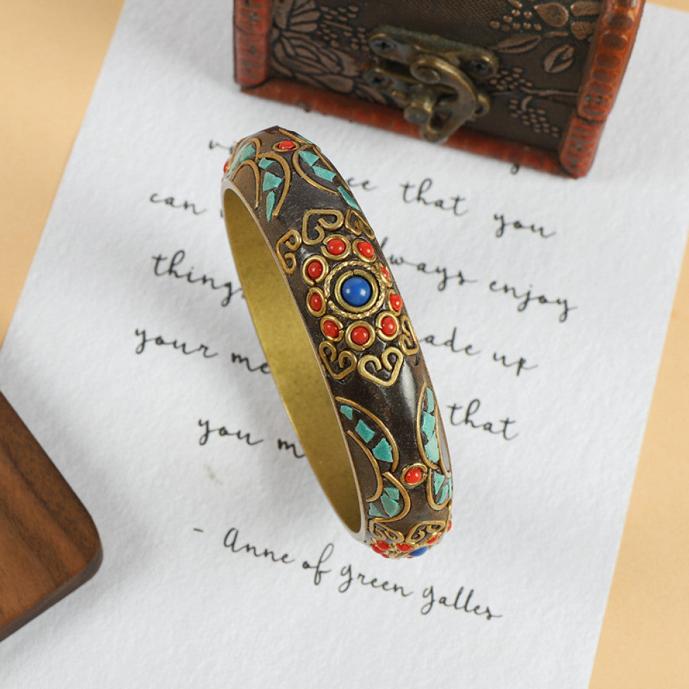 Vintage bohemian ethnic enamel bangle with colorful stone inlays and gold-tone accents, displayed on paper with decorative text and a vintage box, ideal for boho fashion enthusiasts 01
